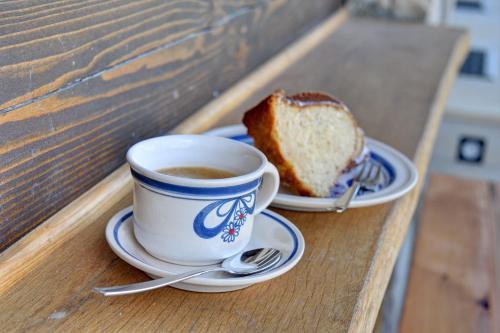 a cup of coffee and a piece of bread on a table at Roubenka pod Troskami in Ktová