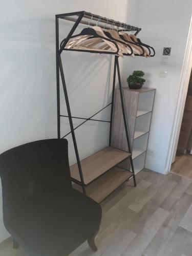 a black chair and a shelf in a room at Chez Flo&Fred in Barbery