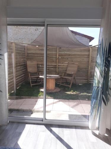 a view of a patio through a sliding glass door at Chez Flo&Fred in Barbery
