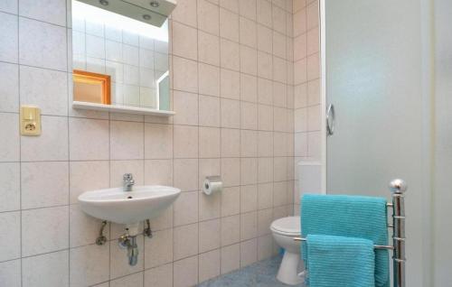 a bathroom with a sink and a toilet and a mirror at Rooms Marija - rooms with pool in Trilj