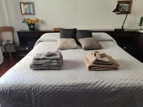 una camera da letto con un letto con asciugamani sopra di Alghero, ottimo appartamento a 100 m. dal mare ad Alghero