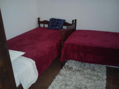 two beds in a room with red sheets at Apartment Gabre Trogir in Trogir