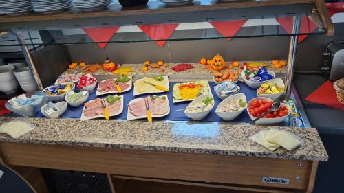 a table with many bowls of food on it at Hotel zum Ochsen in Wonsheim