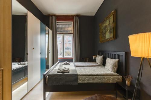 a bedroom with a bed and a bathroom at Westend apartment in Budapest