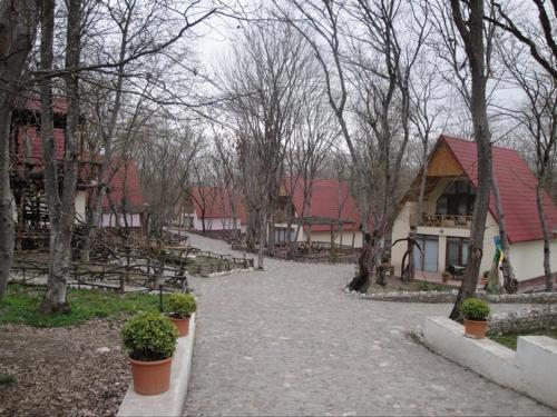 a driveway leading to a house with a red roof at Arena Hotel Gusar in Qusar