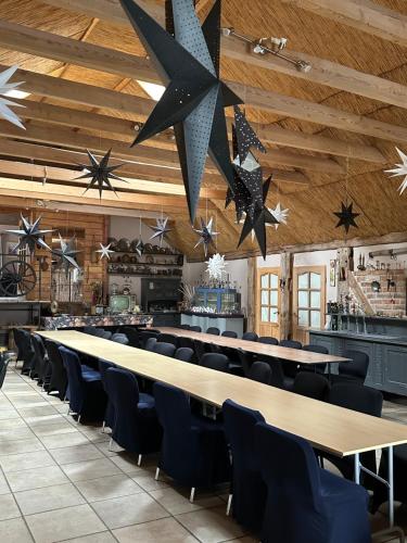 a large dining room with long tables and chairs at Samsara - Prawdziwa Agroturystyka in Łukta