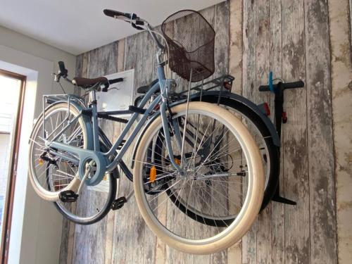a blue bike hanging on a wall at Rest House - Vila do Conde in Vila do Conde