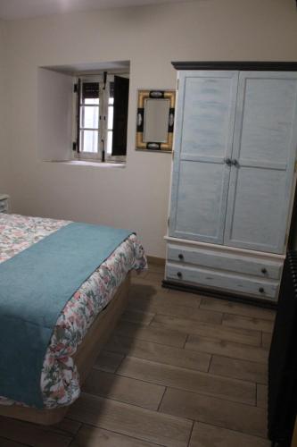 a bedroom with a bed and a dresser at Lua Bierzo in Molinaseca