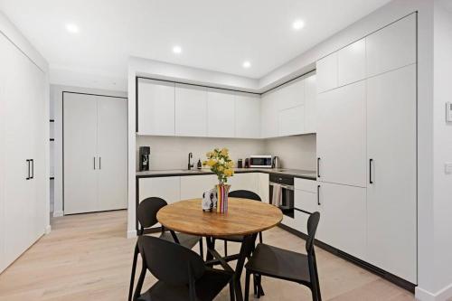 a dining room with a table and chairs in a kitchen at Love Peace and Style in Melbourne