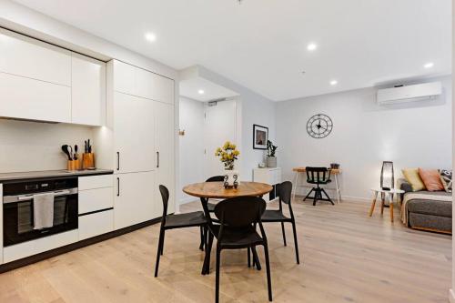 a kitchen and living room with a table and chairs at Love Peace and Style in Melbourne