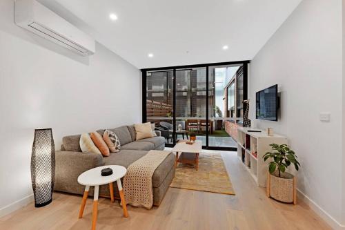 a living room with a couch and a table at Love Peace and Style in Melbourne