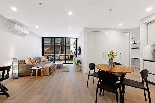 a living room with a table and a couch at Love Peace and Style in Melbourne