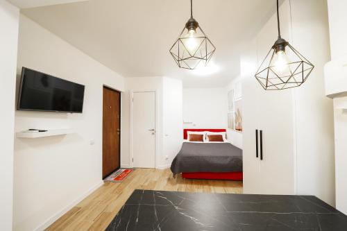 a bedroom with a bed and a tv in a room at Апартаменти MYFREEDOM поруч із метро Чернігівська in Kyiv