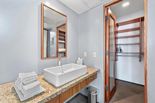 a bathroom with a white sink and a mirror at 14 West Boutique Hotel in Laguna Beach