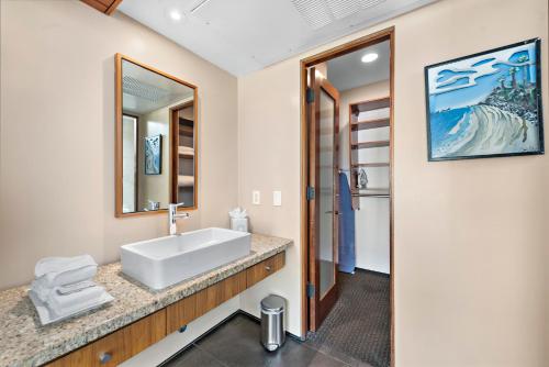 a bathroom with a sink and a mirror at 14 West Boutique Hotel in Laguna Beach