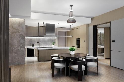 a kitchen and dining room with a table and chairs at JW Marriott Shanghai Fengxian in Shanghai