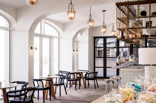 a restaurant with tables and chairs and windows at One&Only Le Saint Géran, Mauritius in Belle Mare