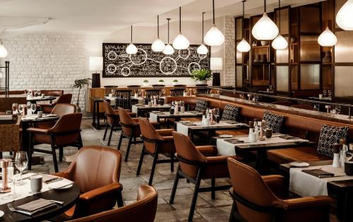 a restaurant with tables and chairs and lights at One&Only Le Saint Géran, Mauritius in Belle Mare