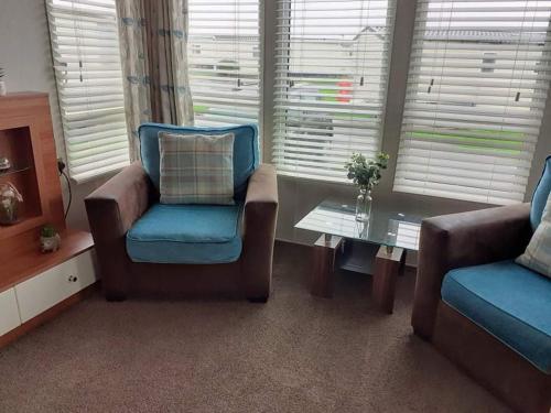 a living room with a couch and a chair and a table at 19 orchid Meadows in Newbiggin-by-the-Sea