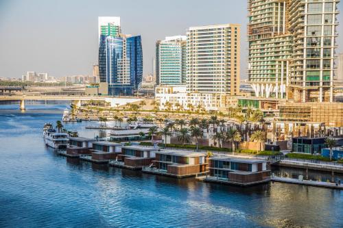 a group of boats docked in a river in a city at Unlock J One Downtown Dubai in Dubai