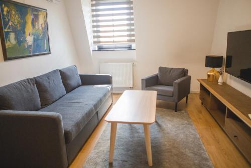 a living room with a couch and a table at Penzión ÁTRIUM in Prešov