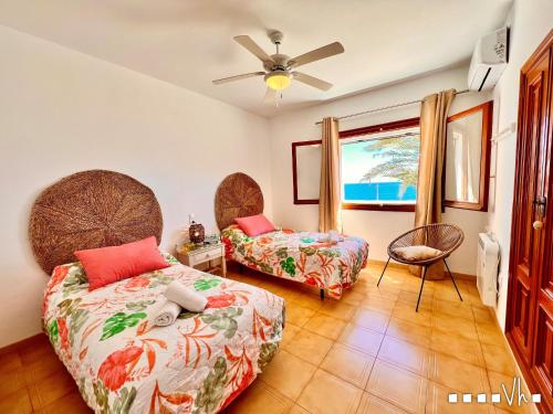 a bedroom with two beds and a window at VH CostaBlanca - EVA in Benissa