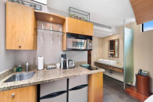 a kitchen with a sink and a counter top at 14 West Boutique Hotel in Laguna Beach