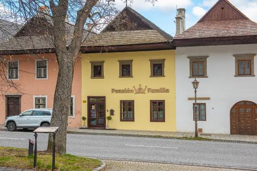 a yellow building on the side of a street at Penzión Familia in Poprad