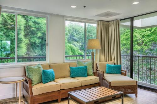 a living room with a couch and windows at Mauna Kea Beach Hotel, Autograph Collection in Hapuna Beach