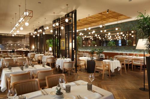 a dining room with white tables and chairs at Four Points by Sheraton Prishtina City in Pristina