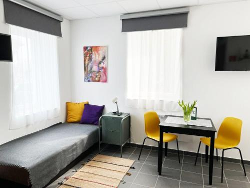 a bedroom with a bed and a table and chairs at Árkádia Vendégház in Lábatlan