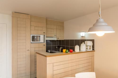 a kitchen with a sink and a counter top at Pierre & Vacances Premium Résidence de la Plage in Le Crotoy