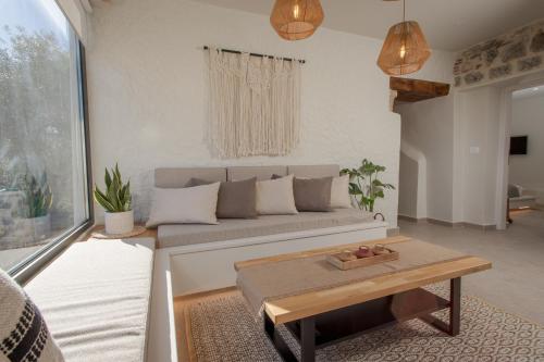 a living room with a couch and a table at Elirion Luxury Home in Kamária