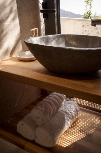 a counter with a sink and some rolls of dough at Elirion Luxury Home in Kamária