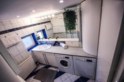 a bathroom with a sink and a washing machine at URBAN LOFT // CITY CENTER // BEST LOCATION VILLACH in Villach