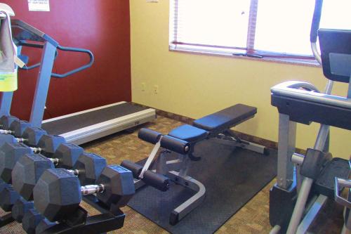 a room with a gym with a bench and weights at Crystal Springs Inn and Suites in Towanda