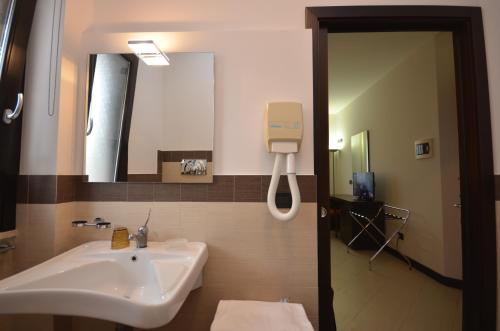 a bathroom with a sink and a mirror at Villa Faro B&B in San Vito lo Capo