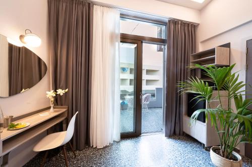 una oficina con escritorio y una planta en Pearl SeaBreeze Suites en Rethymno