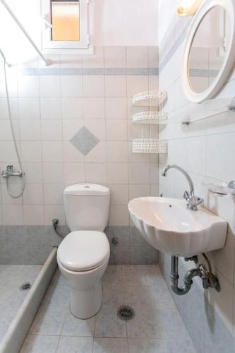 a bathroom with a toilet and a sink at "Triacanthos" 3 bedroom house in Moutsoúna