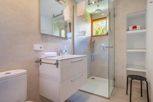a bathroom with a toilet and a sink and a shower at Casa Ca'n Munar in Portocolom