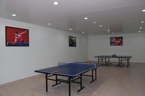 a room with two ping pong tables in it at Arena Hotel Gusar in Qusar
