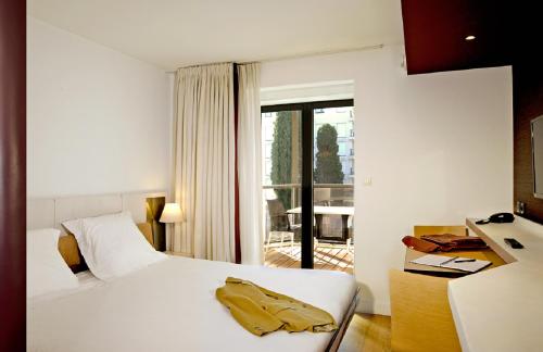 a hotel room with a bed and a window at Résidence Residéal Premium Cannes in Cannes