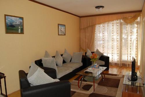 a living room with a couch and a table at Arena Hotel Gusar in Qusar