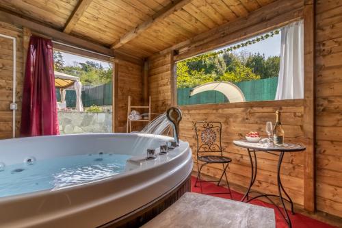 a bath tub in a wooden room with a table at Luxury Summer House in La Spezia