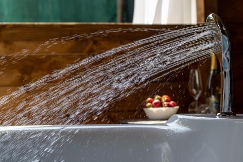 a water faucet with a bowl of fruit in a sink at Luxury Summer House in La Spezia