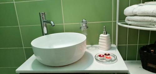 a white bowl on a sink in a bathroom at Apartman Studio DIAMOND in Subotica