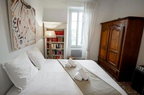 - une chambre avec un grand lit blanc et 2 serviettes dans l'établissement Little Beauty Yourhosthelper, à Villedaigne