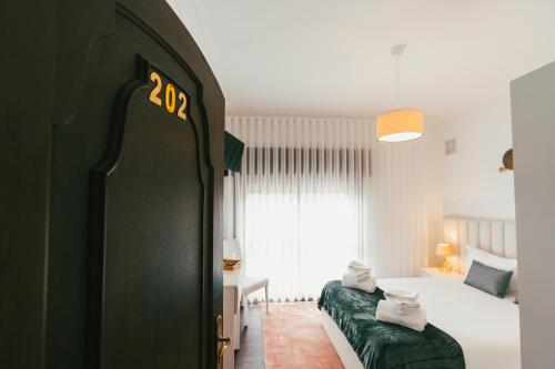 a hotel room with two beds and a window at Quinta da Costinha in Alijó