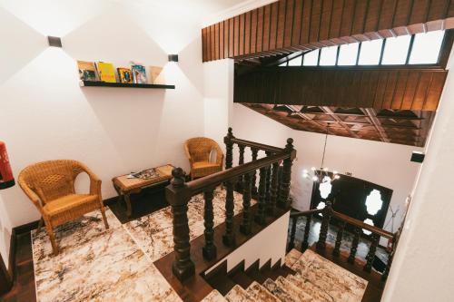 a winding staircase with two chairs and a television at Quinta da Costinha in Alijó