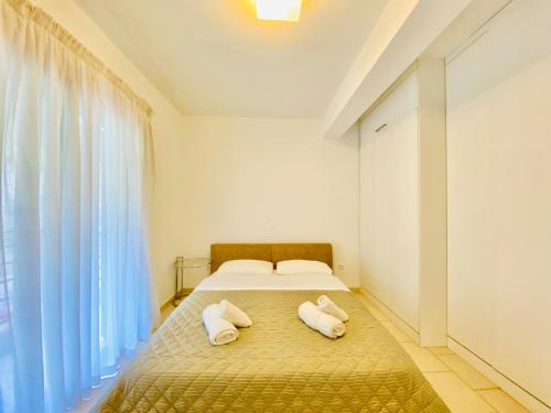 a bedroom with a bed with two pillows on it at Elenos Villa in Possidi